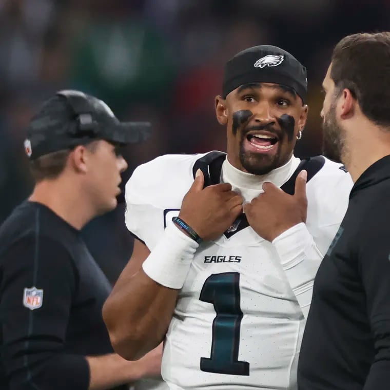 Eagles quarterback Jalen Hurts talks to head coach Nick Sirianni during the first quarter of the season opener against the Green Bay Packers.