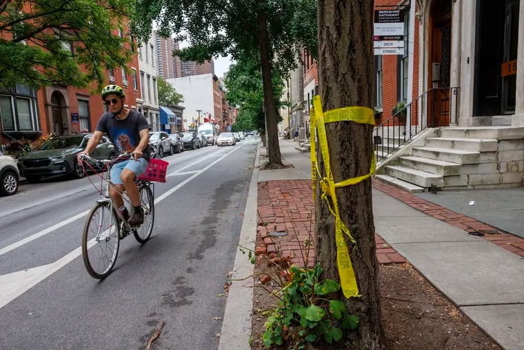 Police tape along the 1800 block of Spruce Street, where a CHOP doctor was killed by a driver while riding her bike on Wednesday.