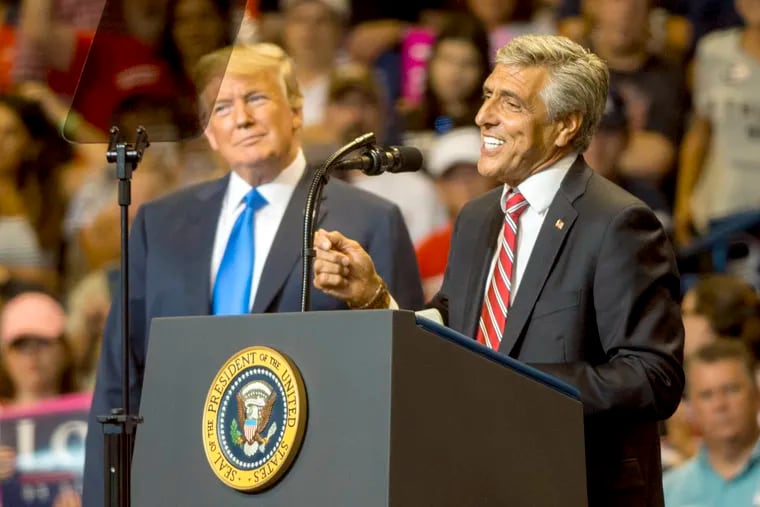 President Trump (left) appears at a campaign rally for U.S. Rep. Lou Barletta at the Mohegan Sun Arena in Wilkes-Barre in August. Although the White House keeps returning to Pennsylvania, outside Republican groups haven't invested much in the top of the ticket.