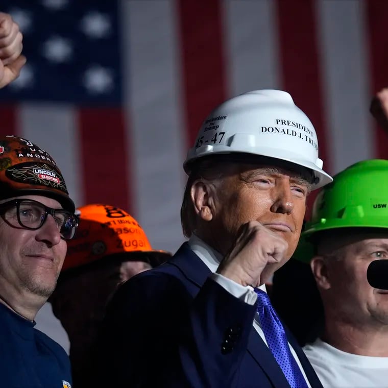 Republican presidential nominee former President Donald Trump stands on stage with steelworkers as he speaks during a campaign rally at Arnold Palmer Regional Airport, Saturday, Oct. 19, 2024, in Latrobe, Pa. (AP Photo/Evan Vucci)