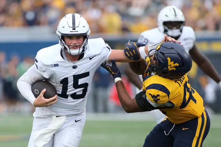 Penn State quarterback Drew Allar stiff-arms West Virginia linebacker Josiah Trotter on Saturday.