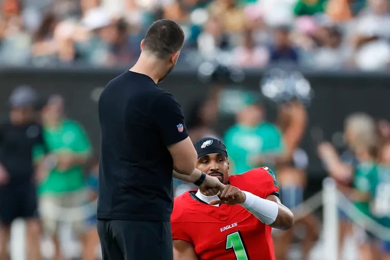 Eagles quarterback Jalen Hurts with head coach Nick Sirianni during the team's public practice at Lincoln Financial Field.
