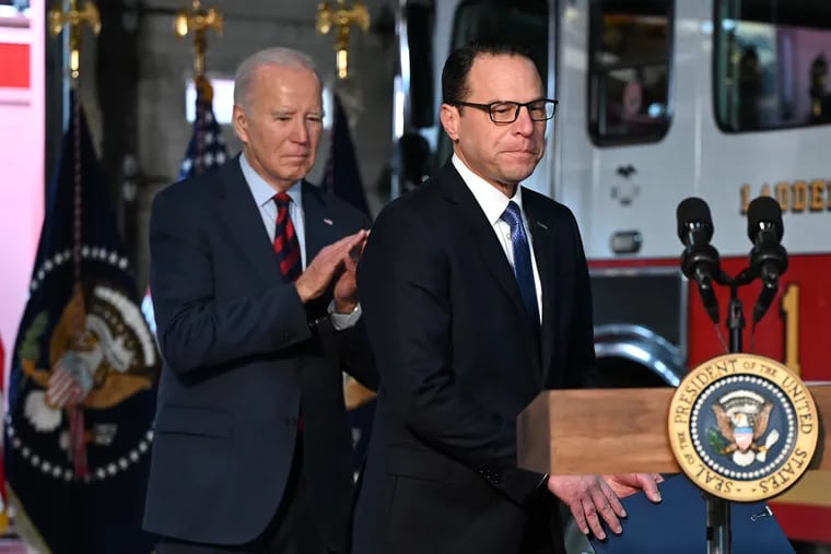 Gov. Josh Shapiro steps to the lectern as President Joe Biden applauds during visit to a Philadelphia fire station in December. Shapiro has remained loyal to Biden amid calls for him to abandon his reelection campaign.
