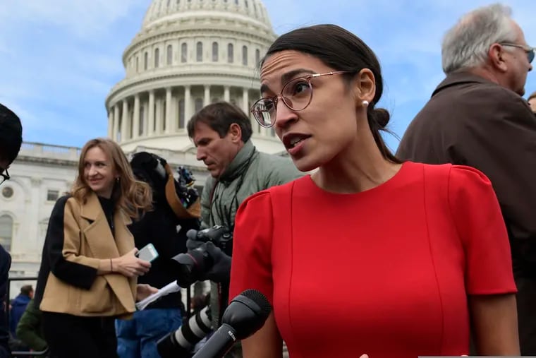 In this Nov. 14, 2018 photo, Rep.-elect Alexandria Ocasio-Cortez, D-N.Y., talks with reporters following a photo opportunity on Capitol Hill in Washington.(AP Photo/Susan Walsh)