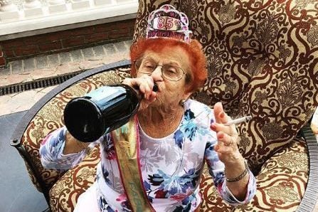 Grandma makes 'need more wine' sign for window in quarantine