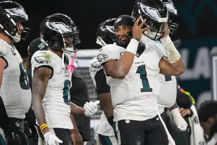 Eagles quarterback Jalen Hurts and Eagles wide receiver DeVonta Smith talk on the sideline during the third quarter in the season opener against the Green Bay Packers at Corinthians Arena in São Paulo, Brazil, Friday, Sept. 6, 2024.