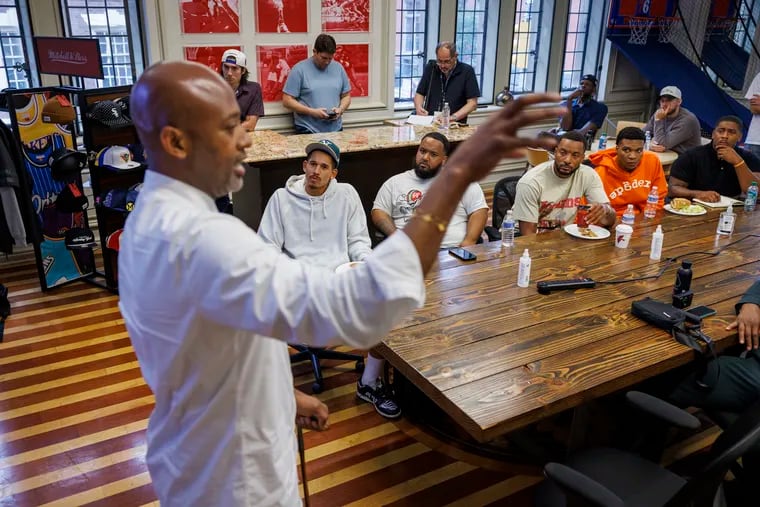 Eli Kumekpor, CEO of Mitchell & Ness, talks with athletes at Mitchell & Ness' corporate office in Philadelphia. The firm is now owned by Fanatics, which sought to immerse athletes in the particulars of its business.