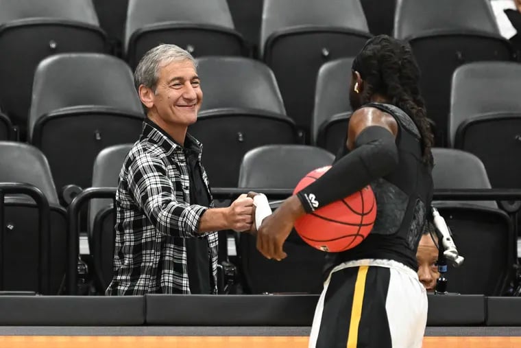 Mike Tollin, co-founder of SlamBall, shakes hands with KyShawn Jones (right) of the Gryphons before a game at the Cox Pavilion in Las Vegas on July 27.