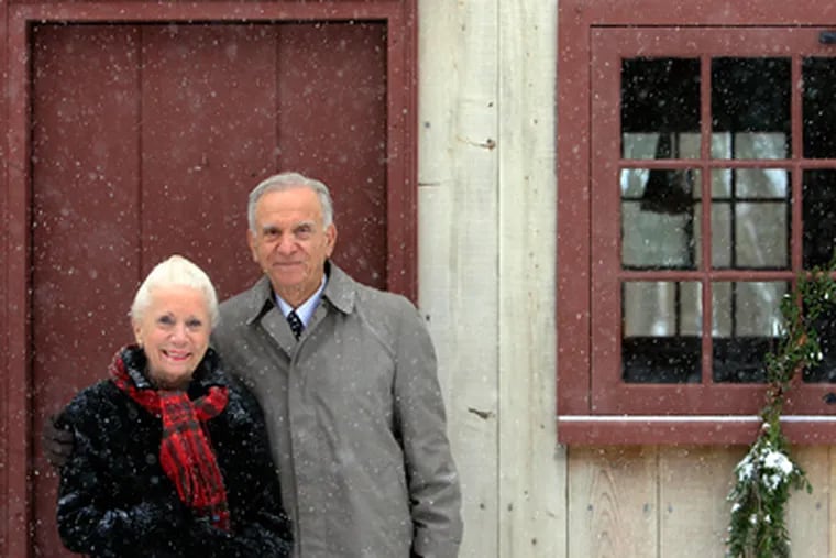 Patricia Salvatore and her husband Joseph Salvatore pose in front of an old building (Cox Hall) in the Cold Spring Village during snowfall. (Akira Suwa / Staff Photographer)