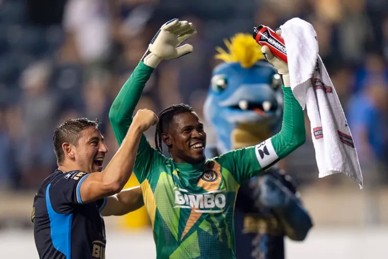 Andre Blake (center) celebrates after his penalty kick shootout heroics for the Union with Alejandro Bedoya.