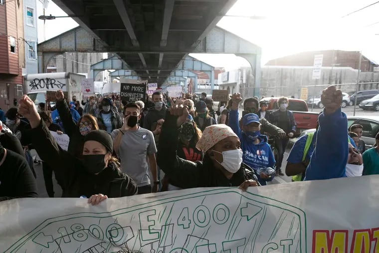 Community members and supporters march underneath the El down Kensington Avenue in protest after the Somerset Station was closed in March for repairs and cleaning. SEPTA said the station had broken elevators and was overwhelmed by drug use and homelessness.