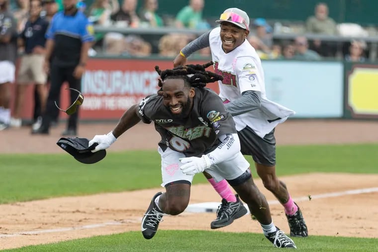Devonta Smith, rights, tags out Shyheim Carter at DeVonta Smith's celebrity softball game and home run derby at Coca-Cola Park in Allentown.