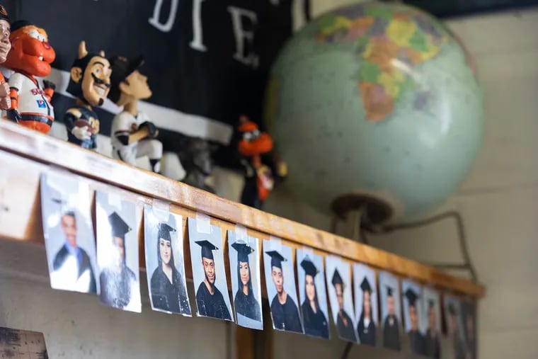 Photos of graduates line a shelf in the classroom of Aaron Cordell at the Bridge Way School, which describes itself as the only recovery high school in the state.