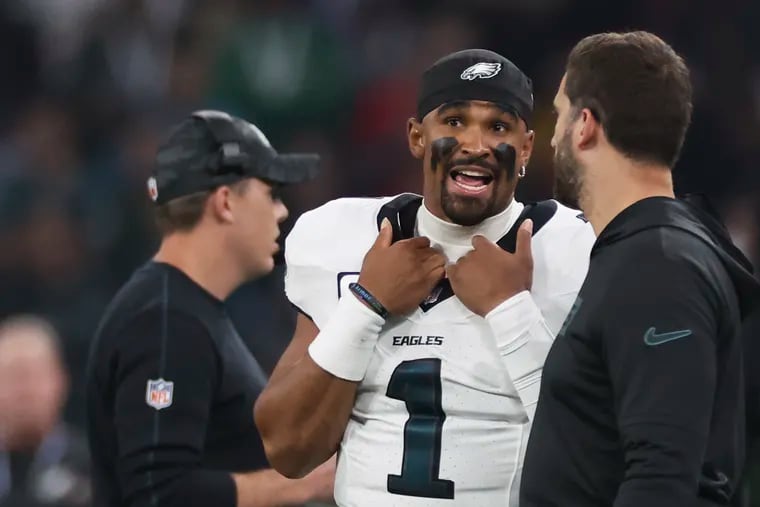 Eagles quarterback Jalen Hurts talks to coach Nick Sirianni during the first quarter of the season opener against the Green Bay Packers at Corinthians Arena in São Paulo, Brazil.