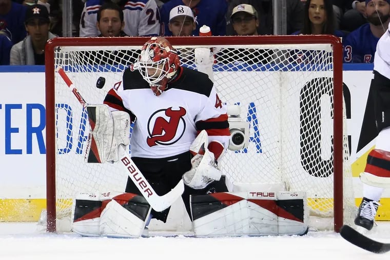 New Jersey Devils goaltender Akira Schmid makes one of 35 saves in his NHL playoff debut Saturday against the New York Rangers. Schmid and the Devils prevailed 2-1 in overtime in Game 3 and can tie the best-of-7 series at 2-2 with another road win Monday night. (Photo by Bruce Bennett/Getty Images)