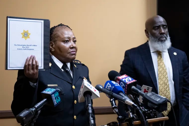 Sheriff Rochelle Bilal and Tariq El-Shabazz host a news conference on Thursday, Sept. 21, 2023, discussing the findings of a recent report released by the City Controller that said her office can't account for nearly 200 guns. In this photo, Bilal is holding an audit that she says accounts for the weapons.