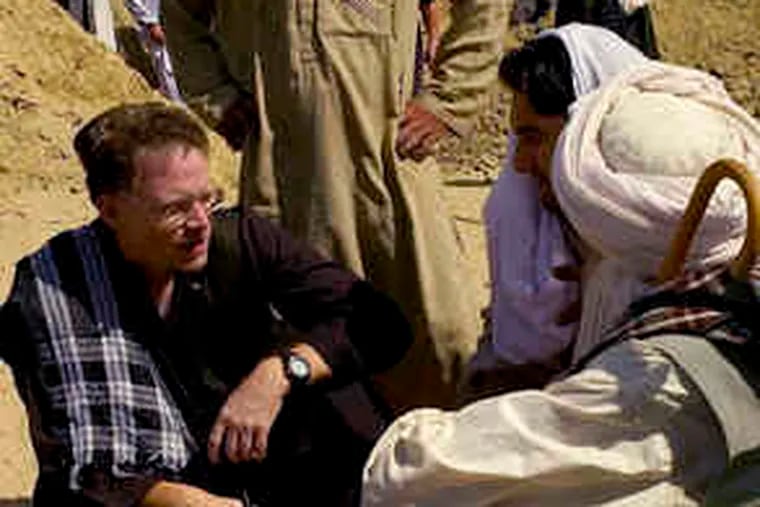 New York Times reporter David S. Rohde interviewing Afghans in a photograph by the Times' Tomas Munita believed to have been taken in 2007 in the Helmand region of Afghanistan.
