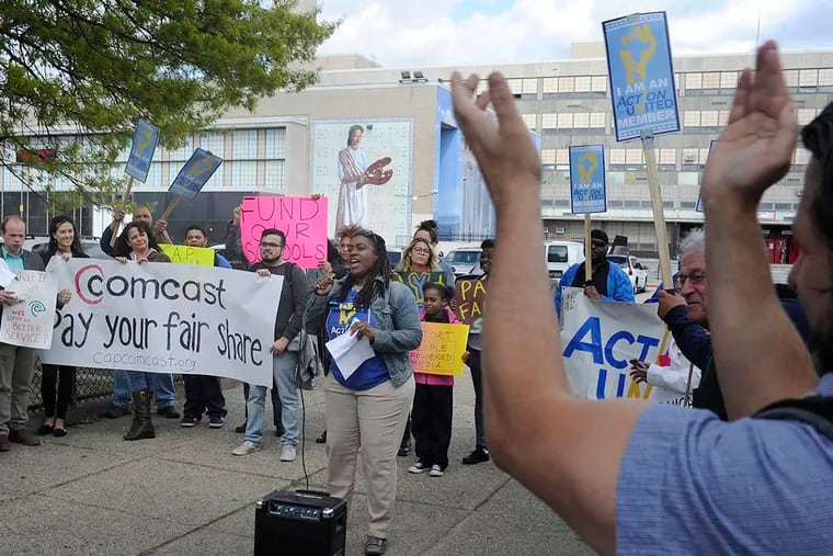 Kia Hinton speaks as ACTION United joins other community groups in a protest outside a hearing at South Philadelphia High School. ( TOM GRALISH / Staff Photographer )