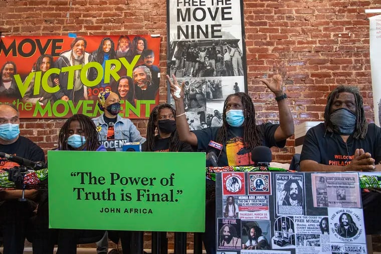 A family member of  MOVE, Consuewella Africa, raises her hands as she speaks during a press conference to denounce how two museums have handled the remains of a group member who died in the 1985 city bombing of their West Philly compound. Monday, April 26, 2021.