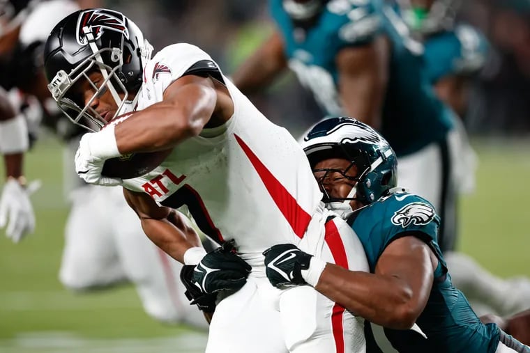 Eagles linebacker Nakobe Dean stops Falcons running back Bijan Robinson in the first quarter at Lincoln Financial Field on Monday. The Eagles had a hard time tackling Robinson all night.