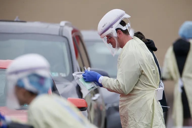 Great caution is warranted around potential coronavirus carriers, as seen with these Penn Medicine workers collecting samples for testing in March. But shunning fully recovered patients? That's just cruel.