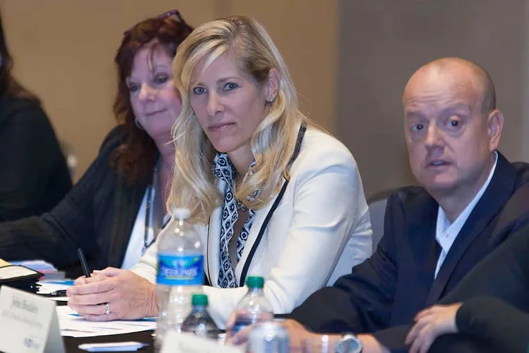 Sandy Vura Harwood (center), vice president of meetings for the Infectious Diseases Society of America, which meets for a convention in Philadelphia starting Wednesday.