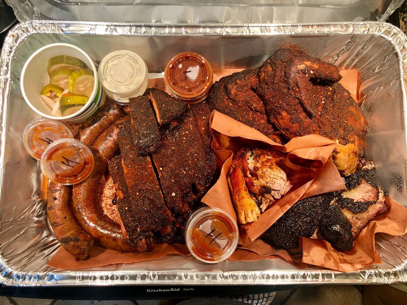 An assortment of smoked meats from the Lucky Well. From left: smoked sausage, dry-rubbed St. Louis cut ribs, pulled pork, a whole chicken and brisket.