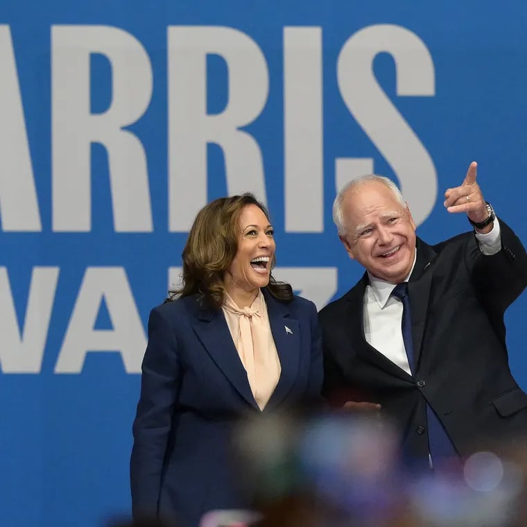 Democratic presidential nominee Kamala Harris and her running mate, Minnesota Gov. Tim Walz, take the stage during a rally at the Liacouras Center on Aug 6, 2024.