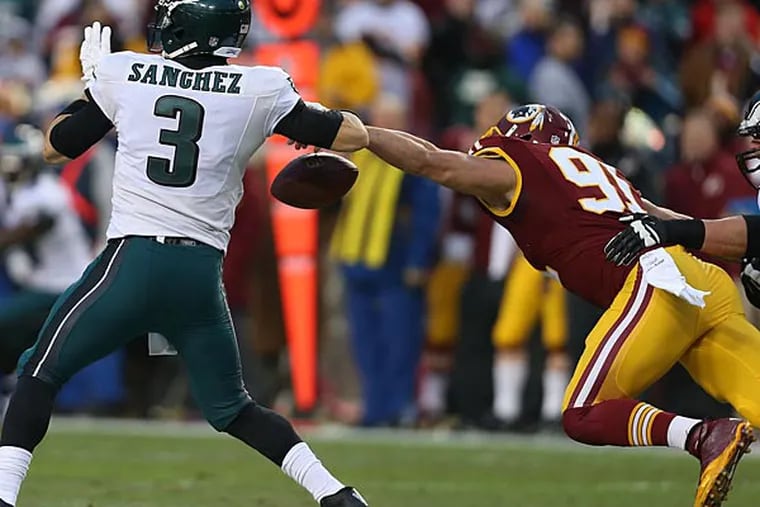 The Redskins' Ryan Kerrigan strips the ball from the Mark Sanchez. (David Maialetti/Staff Photographer)