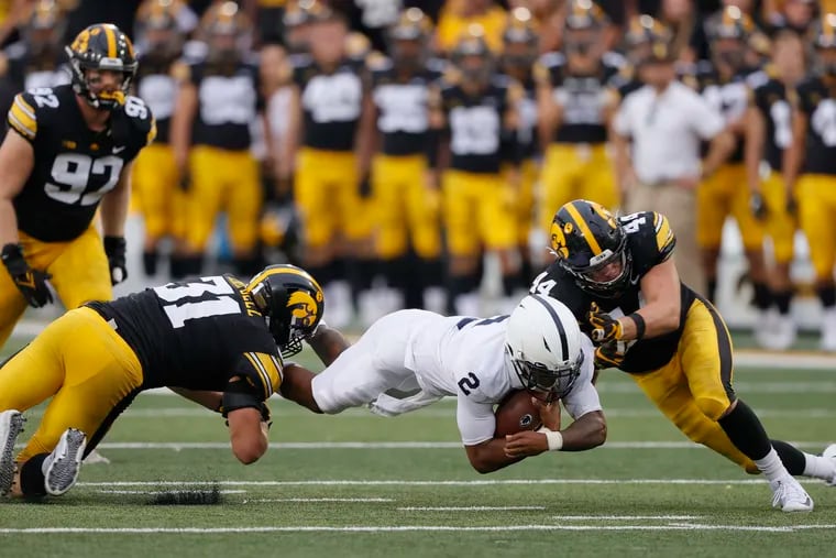 Penn State quarterback Ta'Quan Roberson dives for more yards as Iowa linebackers Jack Campbell (31) and Seth Benson (44) make the tackle during the second half Saturday.