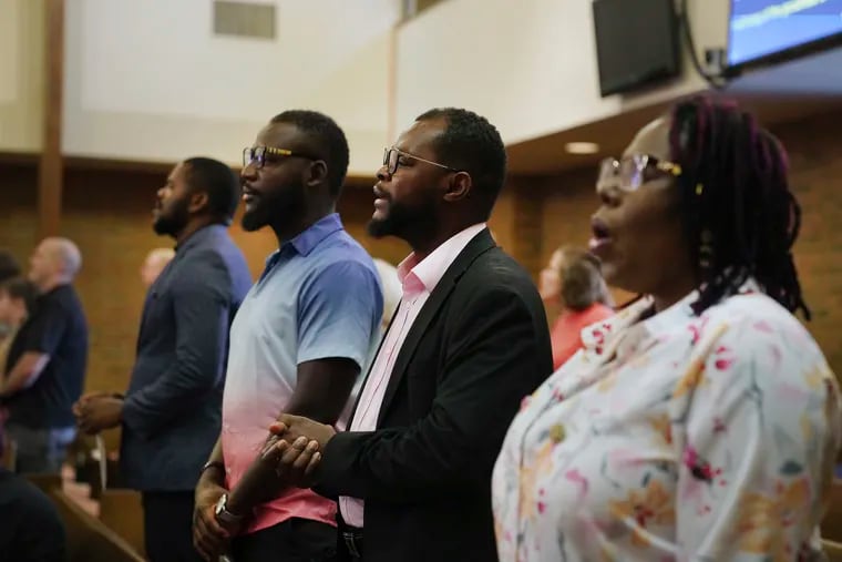 Members of the Haitian community in Springfield, Ohio, from left, Lindsay Aime, James Fleurijean, Viles Dorsainvil, and Rose-Thamar Joseph, stand for worship at Central Christian Church, on Sunday, Sept. 15, 2024.