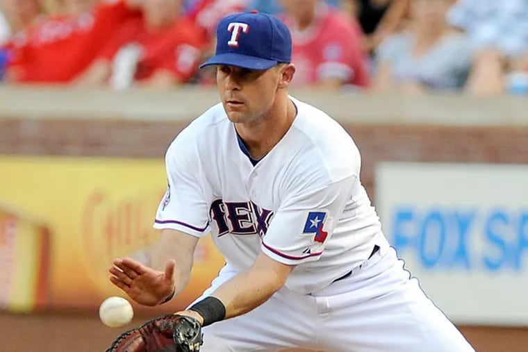 Texas Rangers' Michael Young, looks on after getting his 211th hit