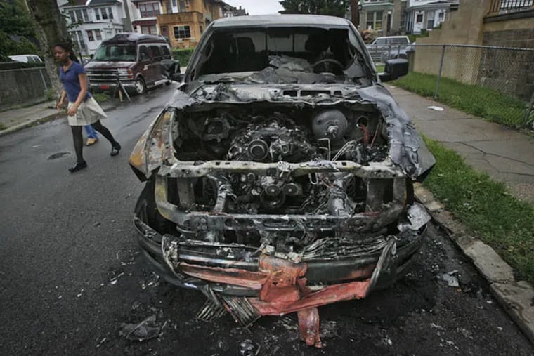 The hood of a Dodge Ram pickup became a gaping hole over a cindery mess of an engine after 7 cars were set on fire in the city's Wynnefield section on May 18, 2011.
