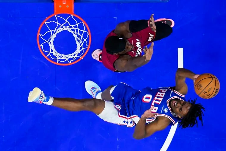 The Sixers' Tyrese Maxey goes up to shoot against Miami Heat's Bam Adebayo, during the first half of an NBA basketball game in March.