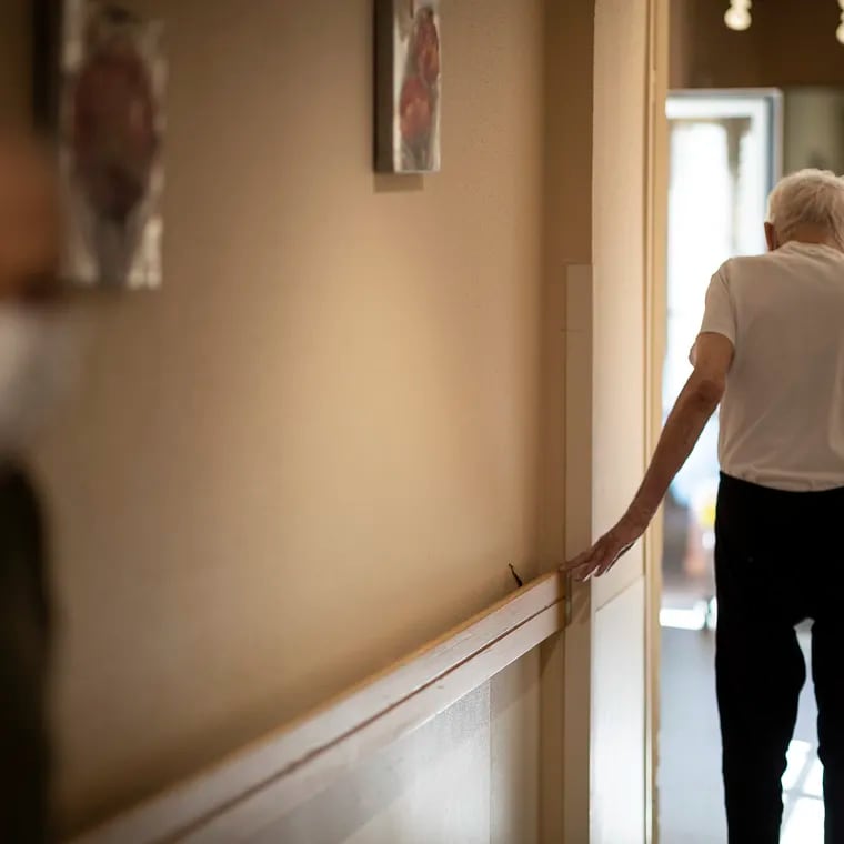 FILE - In this April 16, 2020, file photo, Richard Eberhardt walks along a corridor at a nursing home in Kaysesberg, France. Countries across Europe are struggling amid the coronavirus pandemic with the dilemma of leaving the elderly and others near death in enforced solitude or whether to allow some personal contact with relatives. At nursing homes, everything is done to keep out visitors who might be infected, and family members are almost always banned from coming to see their loved ones. (AP Photo/Jean-Francois Badias, File)