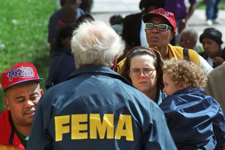 A FEMA official with Eastwick residents after Hurricane Floyd flooded the neighborhood in 1999.