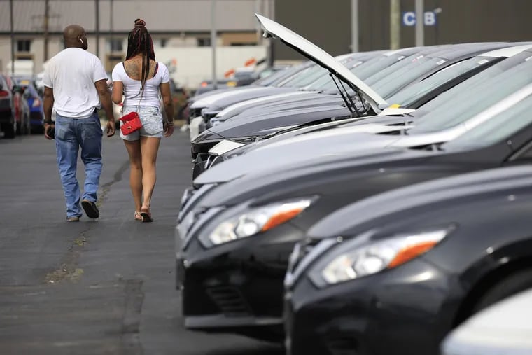 Customers shop for used vehicles at a dealership in Louisville, Ky.