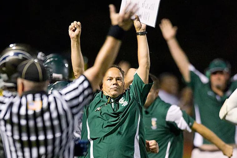 Camden Catholic's head coach Gil Brooks thrusts his hands in the air after an interception. This play essentially sealed the win for Camden Catholic. (Ed Hille/Staff Photographer)