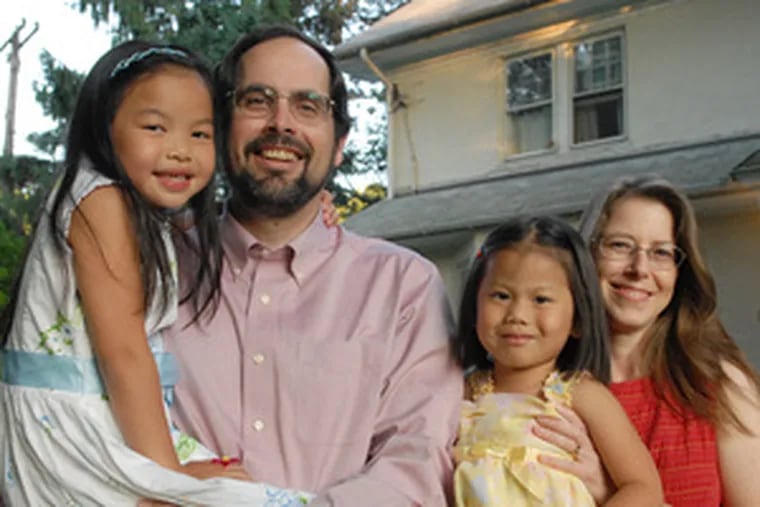 Jeff and Christine Gammage with Jin Yu (left), now 6, and Zhao Gu, 4, at their Elkins Park home.
