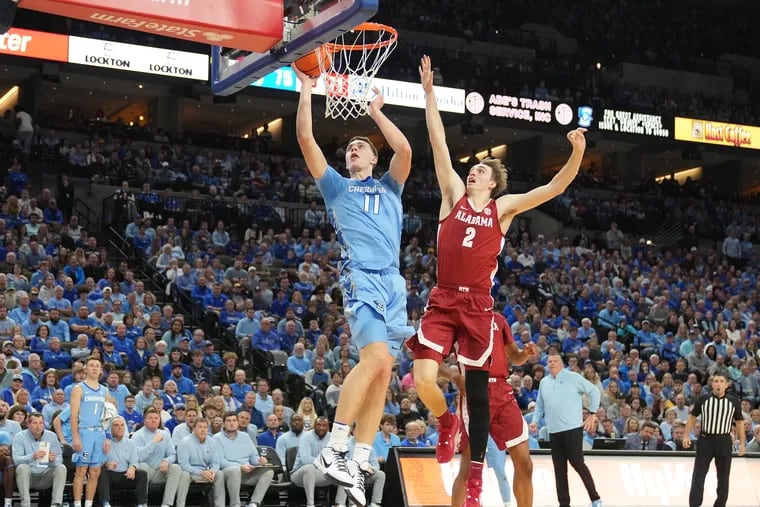 OMAHA, NE - DECEMBER 16:  Ryan Kalkbrenner #11 of the Creighton Bluejays drives to the basket past Grant Nelson #2 of the Alabama Crimson Tide in the second half during a college basketball game at the CHI Health Center on December 16, 2023 in Omaha, Nebraska.  (Photo by Mitchell Layton/Getty Images)