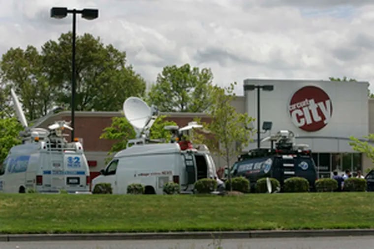 Media trucks at a Mount Laurel Circuit City store , the workplace of an unidentified clerk who provided a tip on an alleged terror plot.