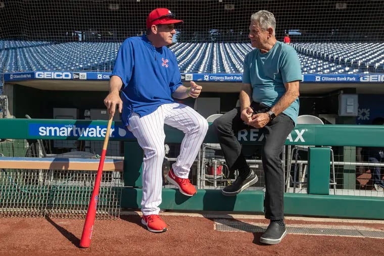 Interim Phillies manager Rob Thomson, left, talks with former Phillies player and manager Larry Bowa before the game against the Angels on Saturday.