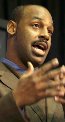 Washington Redskins new quarterback Donovan McNabb holds a jersey, after  head coach Mike Shanahan introduced McNabb to the team, at a press  conference at Redskins Park in Ashburn, Virginia on April 6