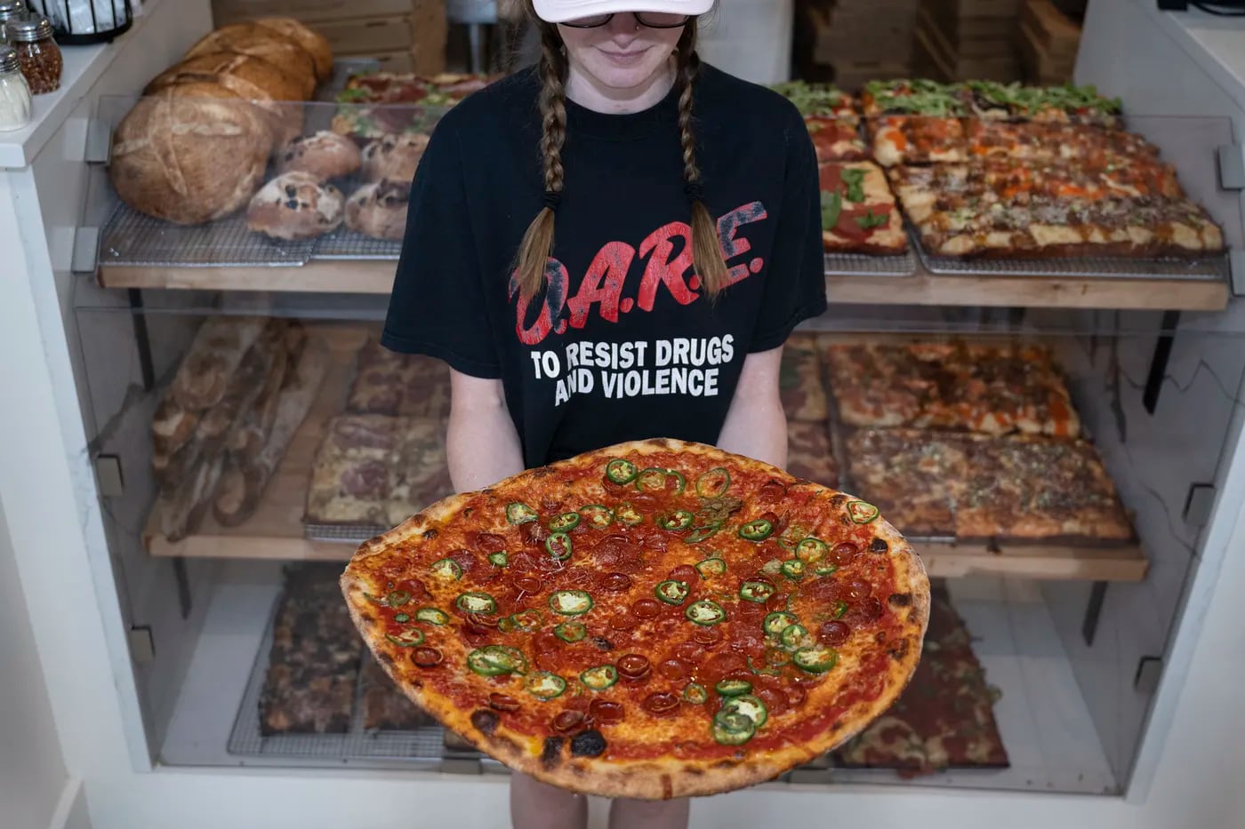 Alicia Curran shows the Spicy 'Roni round pie at Bakeria 1010, which also has some of the best Detroit-style pizza in the region.