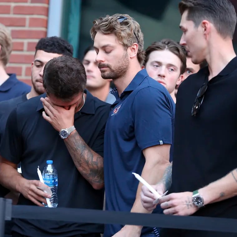 Columbus Blue Jackets players mourn the death of former teammate Johnny Gaudreau at Wednesday's vigil.