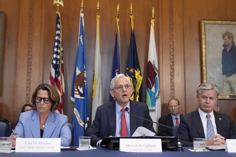 Attorney General Merrick Garland speaks during a meeting of the Justice Department's Election Threats Task Force on Wednesday in Washington, with Deputy Attorney General Lisa Monaco (left) and FBI Director Christopher Wray (right)