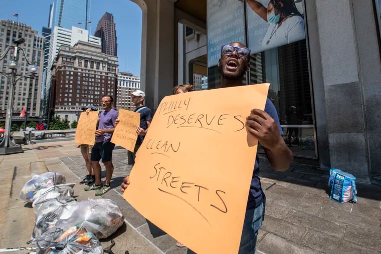Former sanitation worker Terrill Haigler, also known as "Ya Fav Trashman," leads a protest at the Municipal Services Building to demand leaders address the city's trash "epidemic."