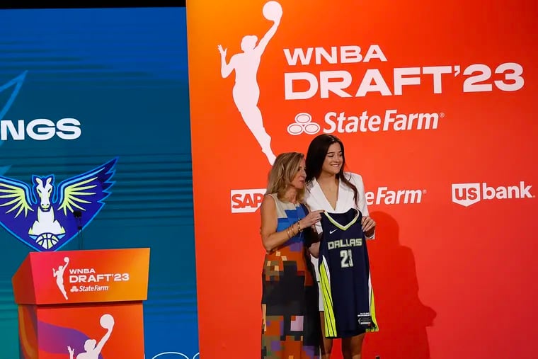 Former Villanova star Maddy Siegrist poses with her Dallas Wings jersey and WNBA Commissioner Cathy Engelbert.