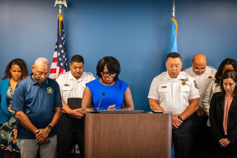 Mayor Cherelle L. Parker holds a moment of silence during a press conference to discuss the death of Officer Jaime Roman, who was shot on duty during a motor vehicle stop in June. He had been hospitalized for nearly three months, and died from his injuries on Sept. 10.