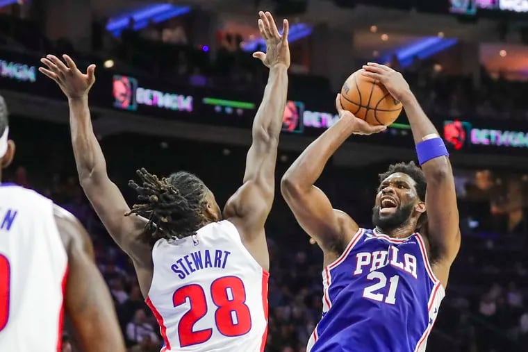 76ers center Joel Embiid shoots and draws a foul on Detroit's Isaiah Stewart in the second quarter at the Wells Fargo Center.